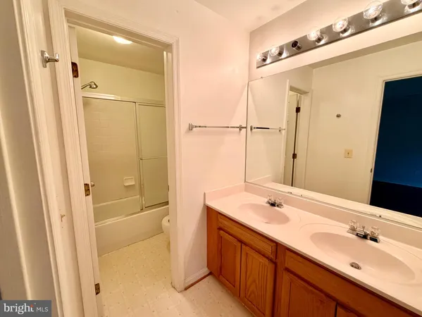 a bathroom with a tub sink and mirror