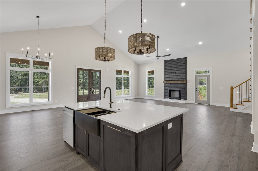 384 Jim Smith Road Pendleton, SC 29670 - Photo 10 of 48 Vaulted ceilings soar over a sprawling open-concept living area anchored by a central kitchen island.