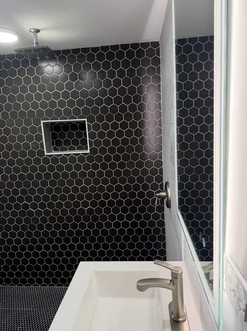 a bathroom with a bathtub and shower