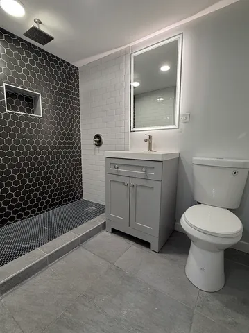 a bathroom with a sink toilet and shower