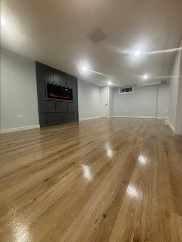a view of a room with wooden floor