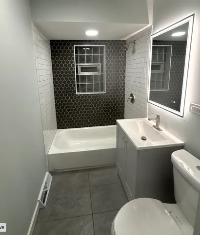 a bathroom with a sink toilet and bathtub