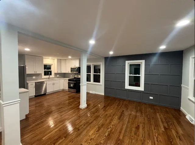 a view of kitchen with wooden floor and windows