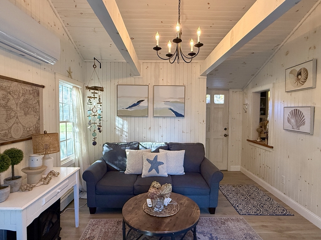 28 Swan Lake Road Yarmouth, MA 02673 - Photo 11 of 19 a living room with furniture a chandelier and a dining table
