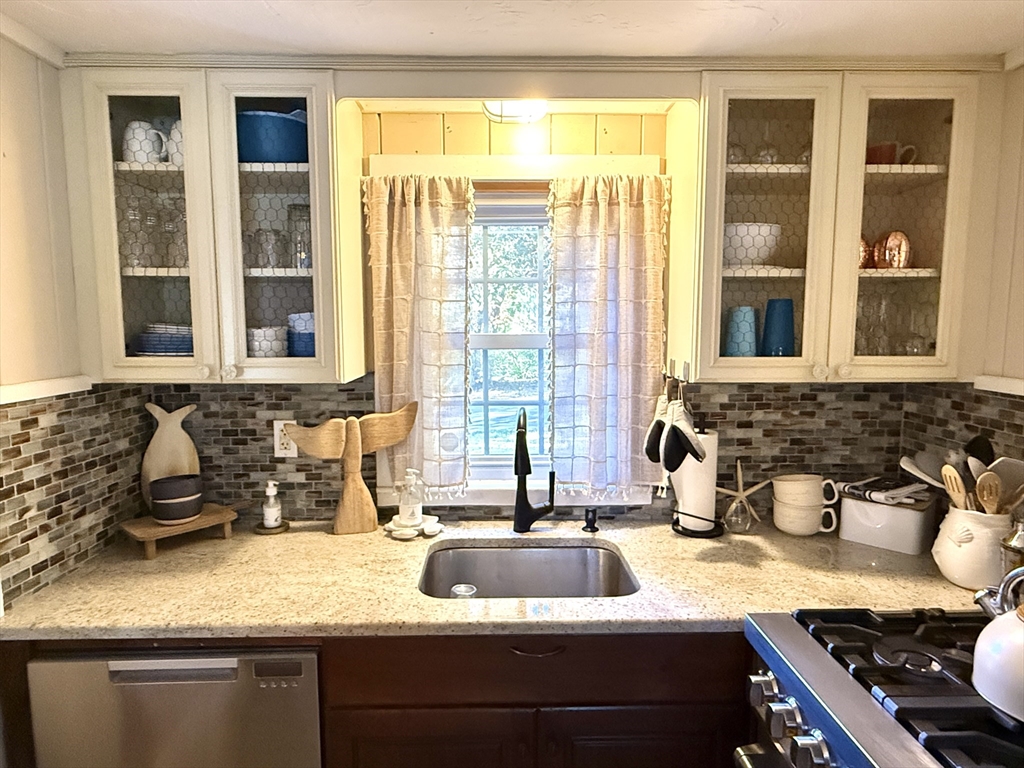 28 Swan Lake Road Yarmouth, MA 02673 - Photo 12 of 19 a kitchen with a sink and a window