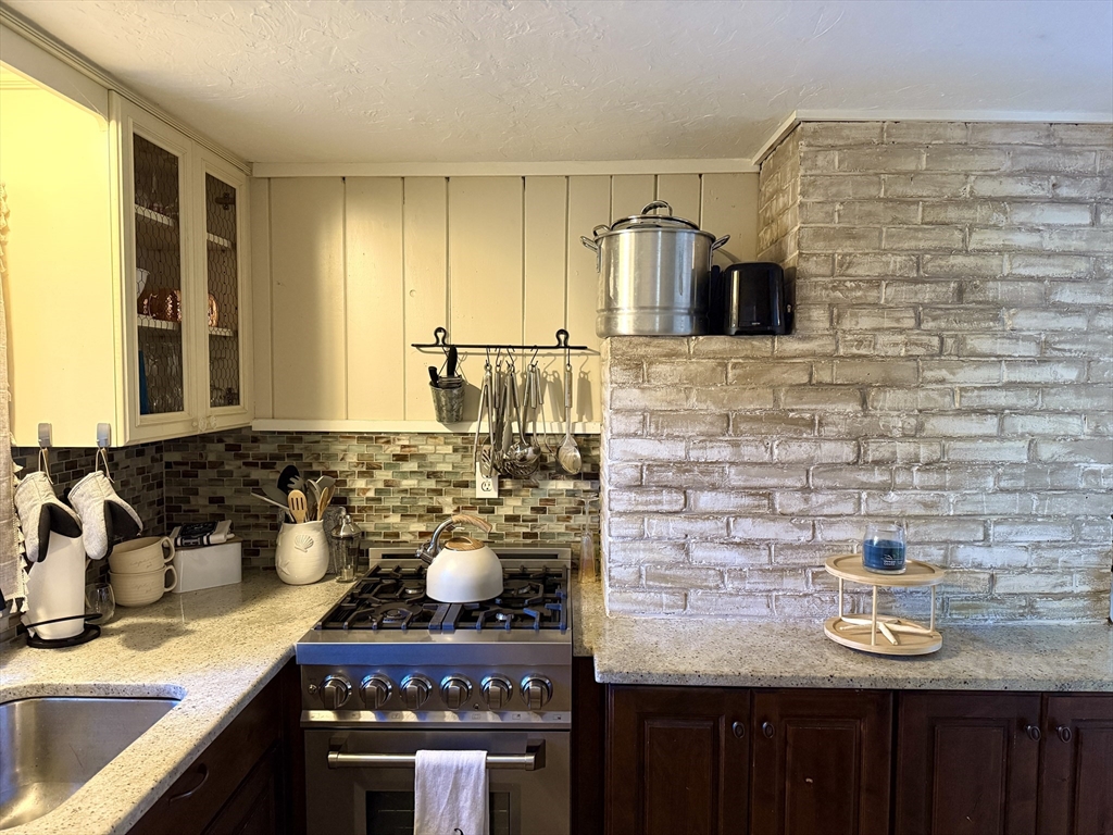 28 Swan Lake Road Yarmouth, MA 02673 - Photo 14 of 19 a kitchen with a stove and a sink
