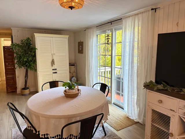 a dining room with furniture and wooden floor