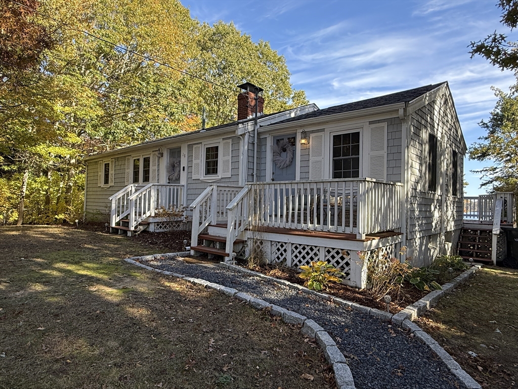 28 Swan Lake Road Yarmouth, MA 02673 - Photo 17 of 19 a view of a house with backyard and sitting area