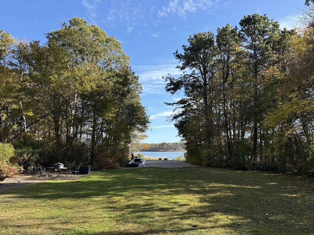 28 Swan Lake Road Yarmouth, MA 02673 - Photo 5 of 19 a view of a large body of water with a building in the background