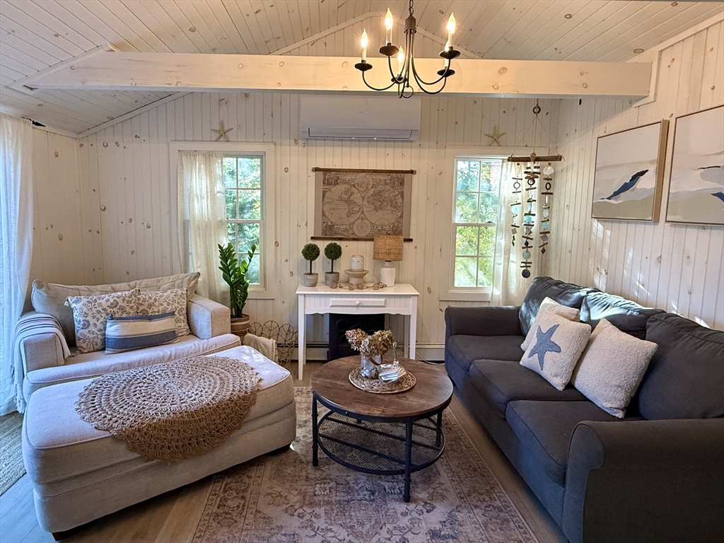 28 Swan Lake Road Yarmouth, MA 02673 - Photo 8 of 19 a living room with furniture and a fireplace