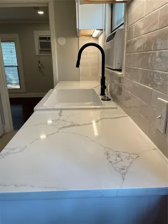 a kitchen with stainless steel appliances granite countertop a refrigerator and a stove