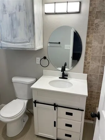 a bathroom with a sink a mirror and vanity
