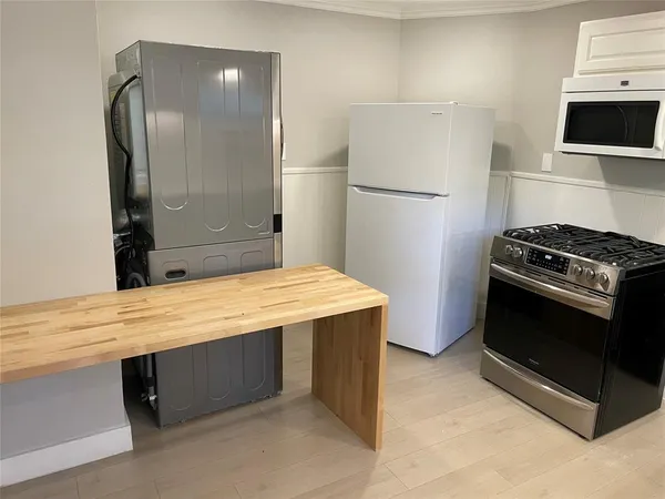 a kitchen with stainless steel appliances a stove a sink and a refrigerator