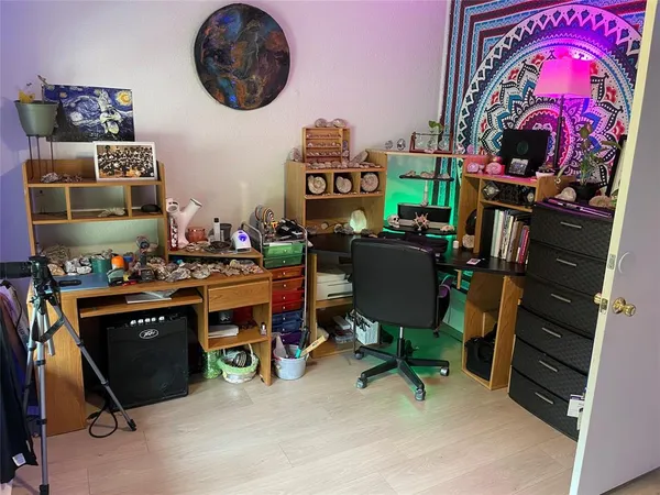 a bedroom with a bed and a night stand