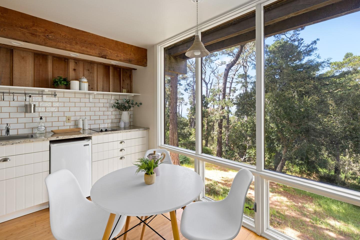 73 Mt Devon Road Carmel Highlands, CA 93923 - Photo 46 of 88 a kitchen with a table chairs and wooden floor