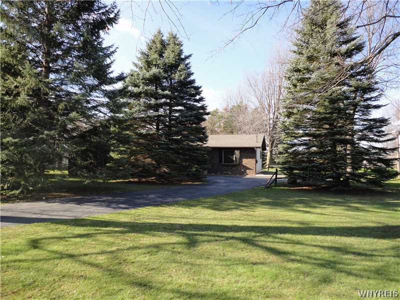 5939 Robinson Road Lockport Town, NY 14094 - Photo 1 of 1 Exterior Front. Pine trees provide privacy from th