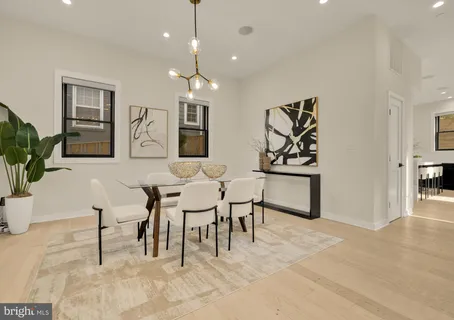 a view of a a dining room with furniture window and wooden floor