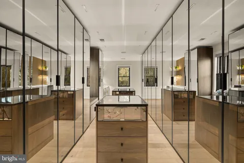 a view of a hallway with dining table and chairs