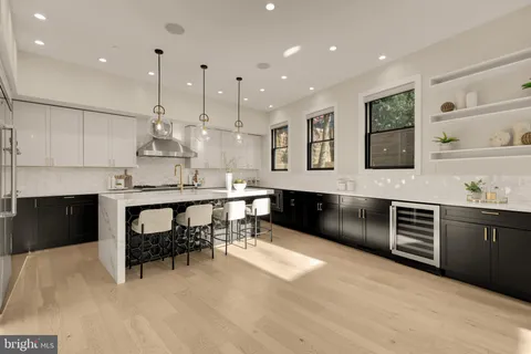 a large kitchen with stainless steel appliances kitchen island granite countertop a stove and a sink