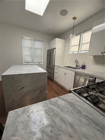 a kitchen with a stove a refrigerator and window