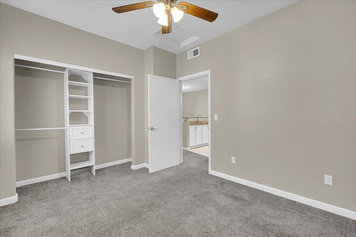4200 East Commerce, Unit 1121 Sacramento, CA 95834 - Photo 14 of 24 an empty room with closet and a ceiling fan