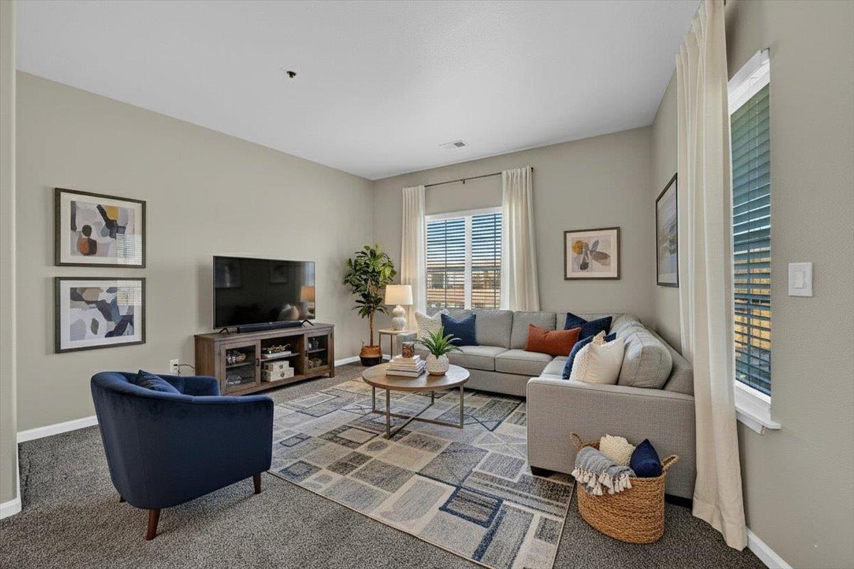 4200 East Commerce, Unit 1121 Sacramento, CA 95834 - Photo 5 of 24 a living room with furniture and a flat screen tv