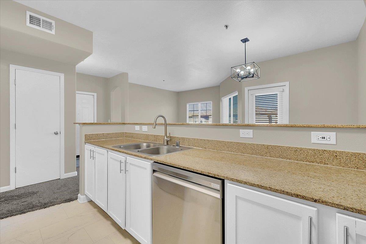 4200 East Commerce, Unit 1121 Sacramento, CA 95834 - Photo 9 of 24 a kitchen with a sink and chandelier