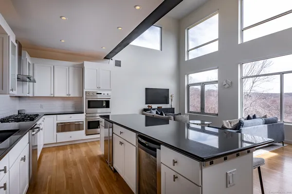 a kitchen with a sink stove top oven and cabinets