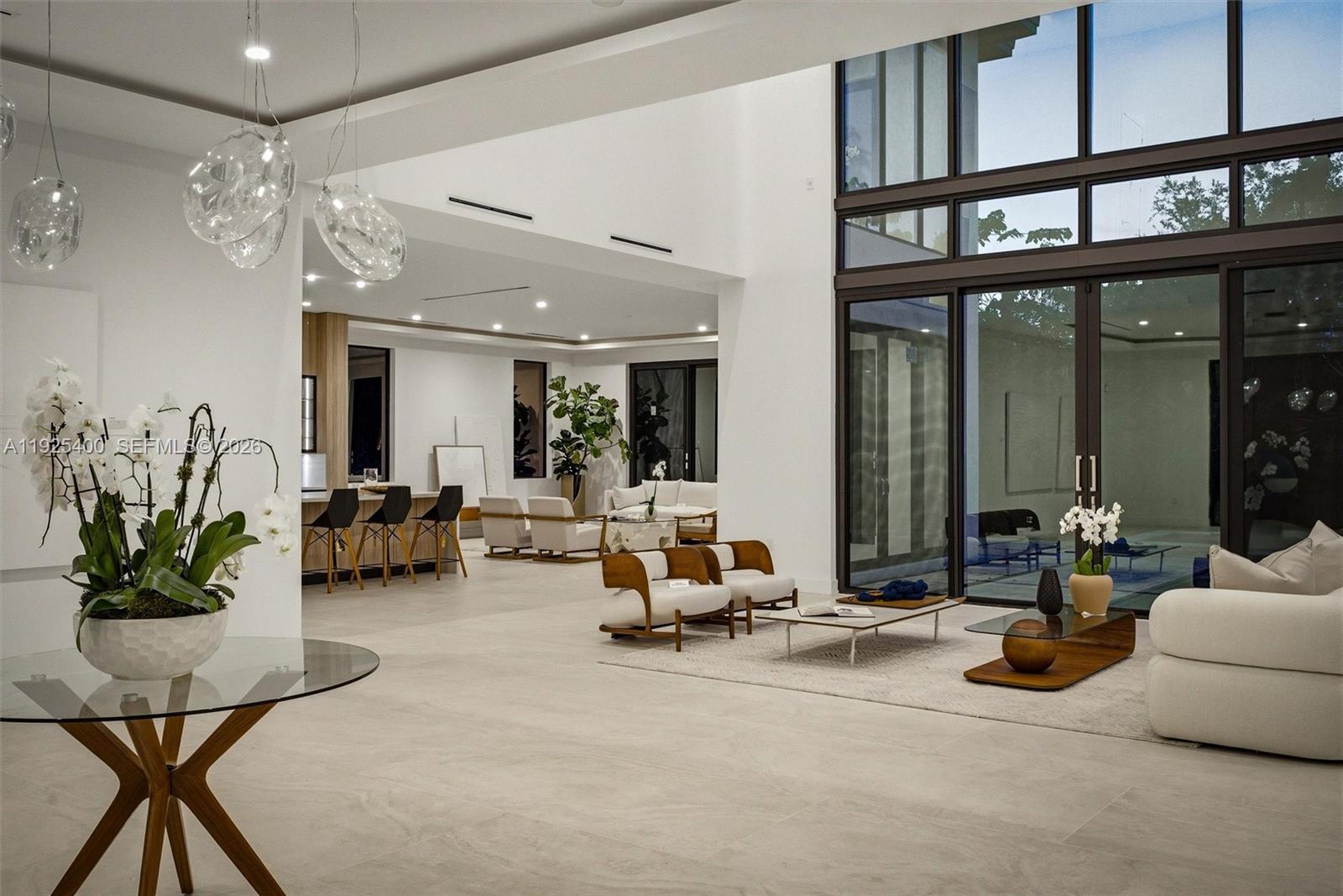 9840 Southwest 73rd Court Pinecrest, FL 33156 - Photo 10 of 67 Open-Concept Living Room | Double-Height Glass Wall | Designer Pendants | Pinecrest FL