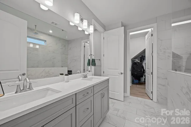 a spacious bathroom with a sink and a mirror
