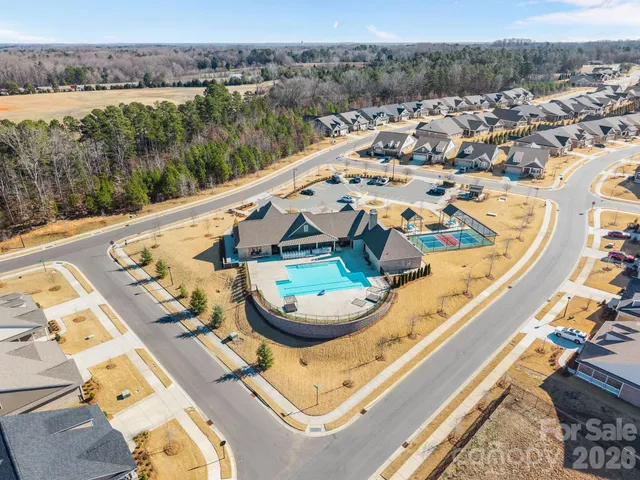 an aerial view of a house with a swimming pool
