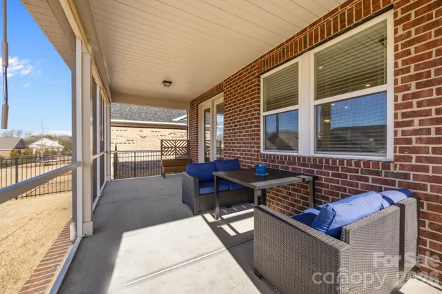 a roof deck with a couch and wooden floor