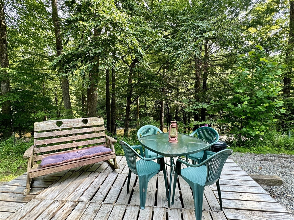 73 Green River Road Colrain, MA 01340 - Photo 3 of 26 a backyard of a house with a table and chairs