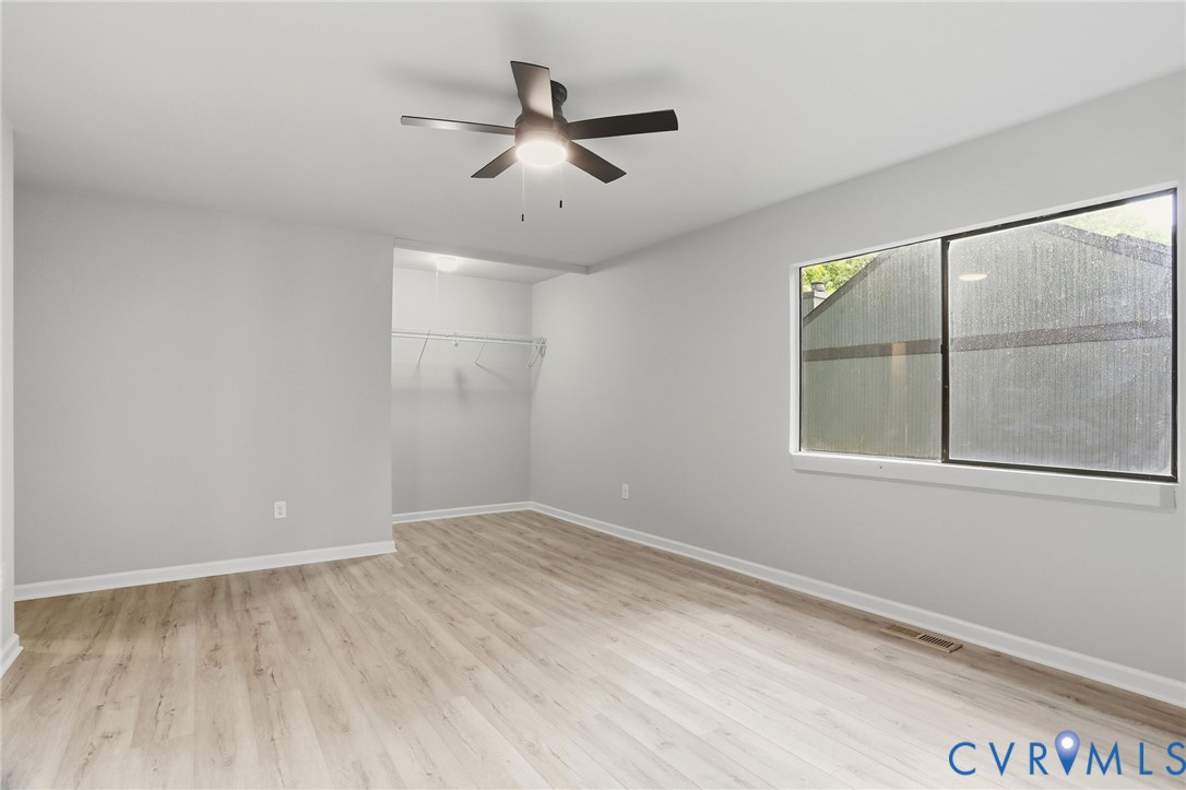 11735 South Briar Patch Drive Midlothian, VA 23113 - Photo 21 of 48 an empty room with windows and fan