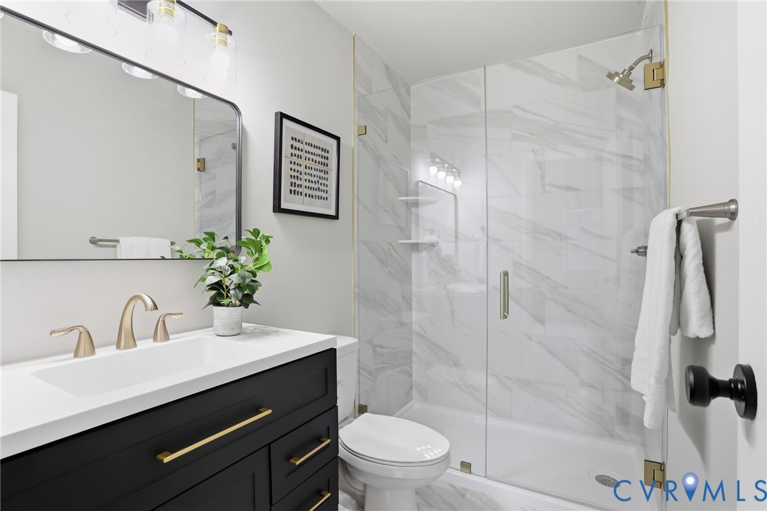 11735 South Briar Patch Drive Midlothian, VA 23113 - Photo 24 of 48 a bathroom with a sink a toilet a mirror and shower