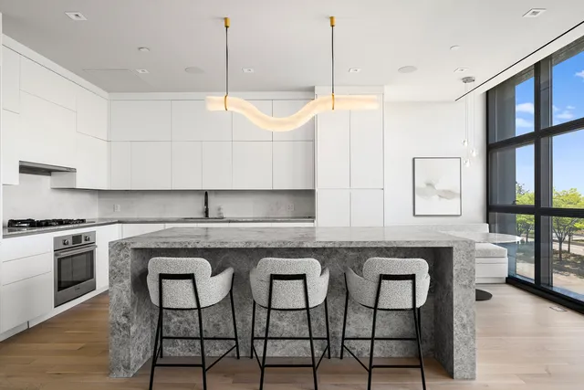 a living room with furniture and a floor to ceiling window