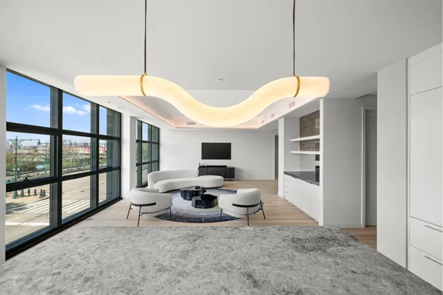 a kitchen with stainless steel appliances granite countertop a stove a refrigerator a sink and white cabinets