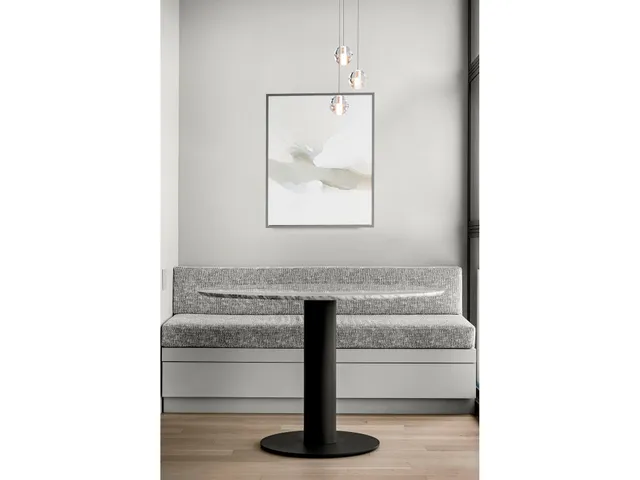 a kitchen with a table chairs and wooden floor