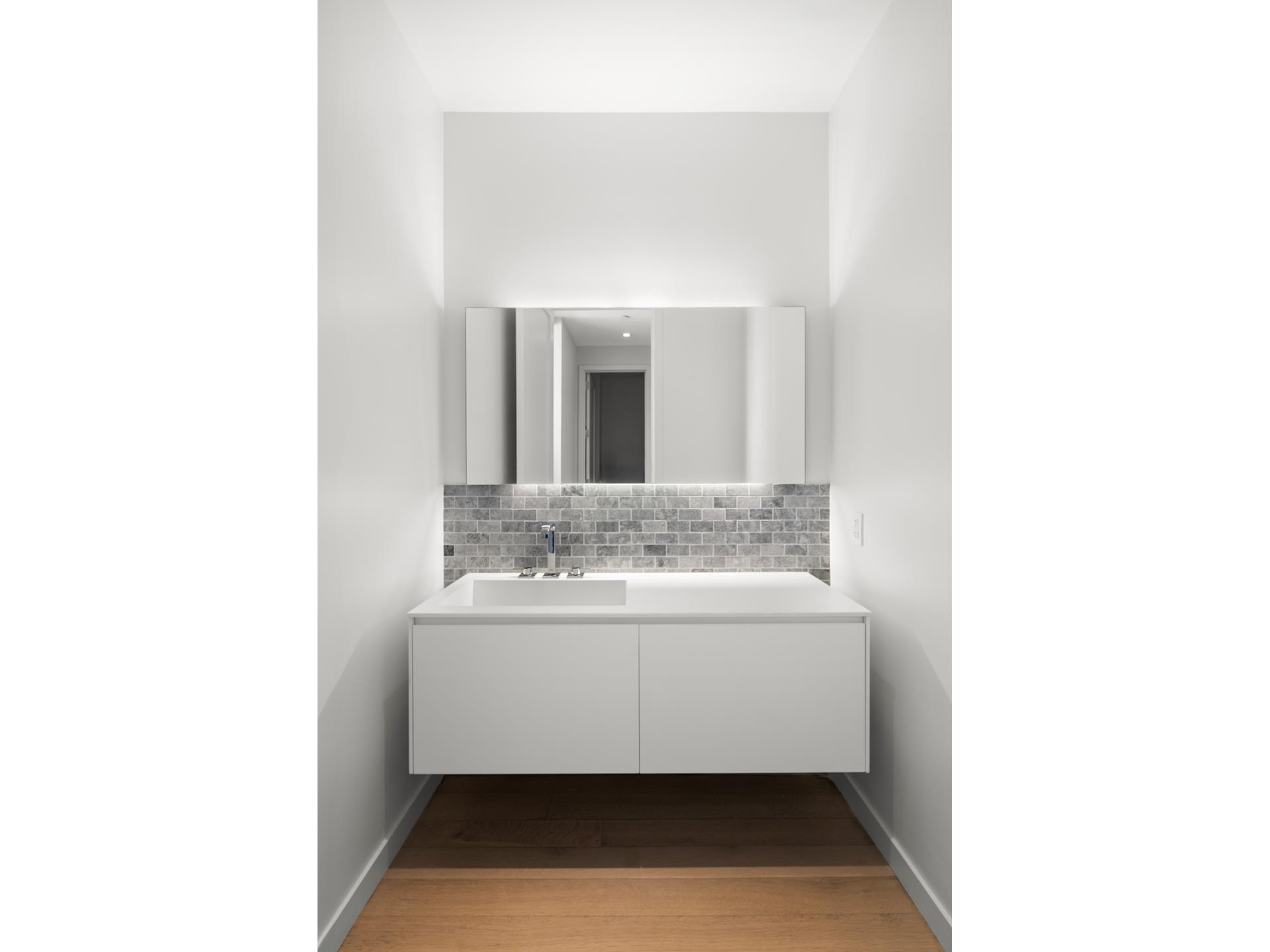 290 West Street, Unit 2B Manhattan, NY 10013 - Photo 7 of 14 a bathroom with a sink and a mirror