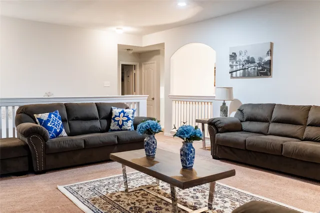 a living room with furniture a rug and a window