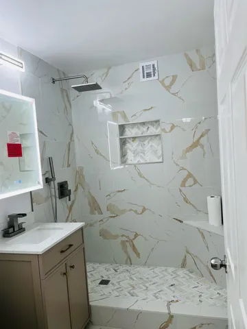 a bathroom with a sink mirror vanity and toilet