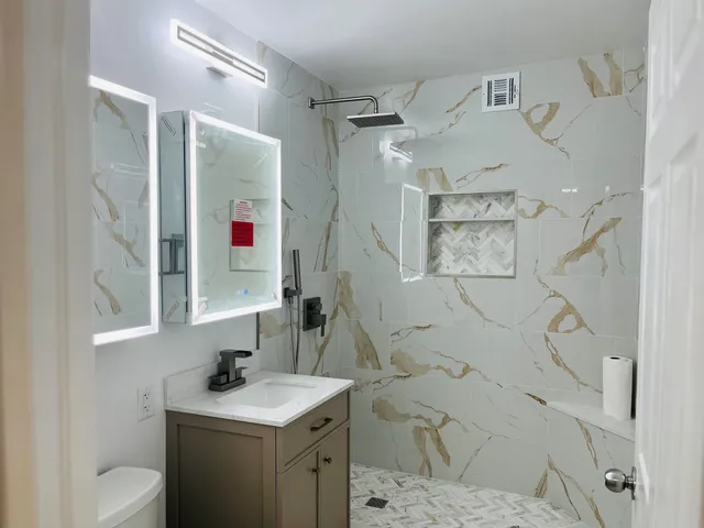 a bathroom with a sink toilet and shower