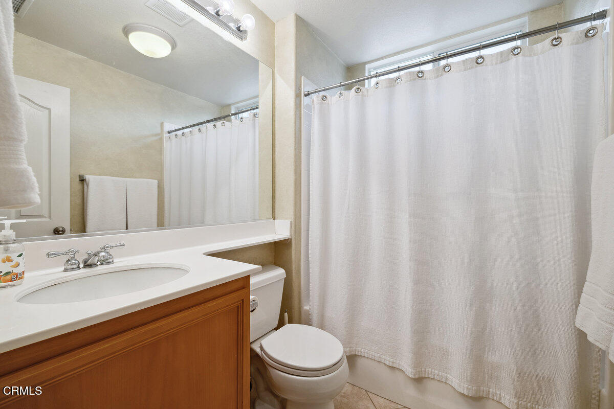 76 Orient Street Fillmore, CA 93015 - Photo 16 of 34 a bathroom with a sink a toilet and shower curtain