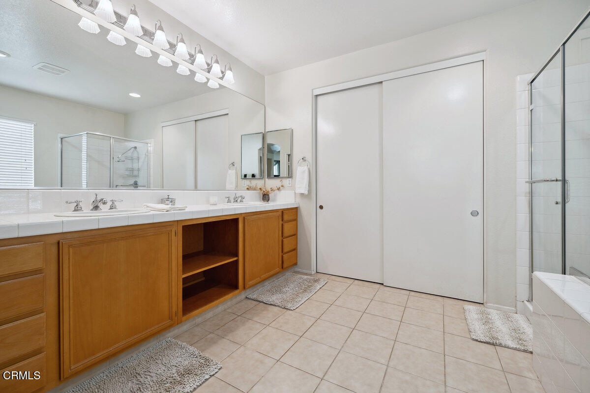 76 Orient Street Fillmore, CA 93015 - Photo 24 of 34 a spacious bathroom with a double vanity sink and a mirror