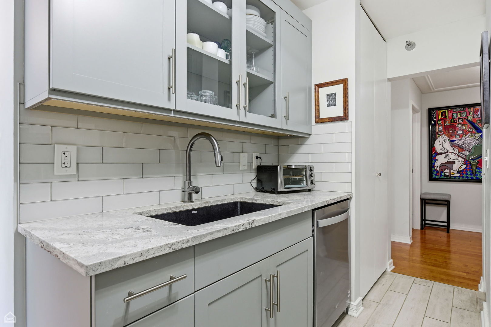 401 East Ontario Street, Unit 710 Chicago, IL 60611 - Photo 13 of 36 a kitchen with stainless steel appliances granite countertop a sink and cabinets
