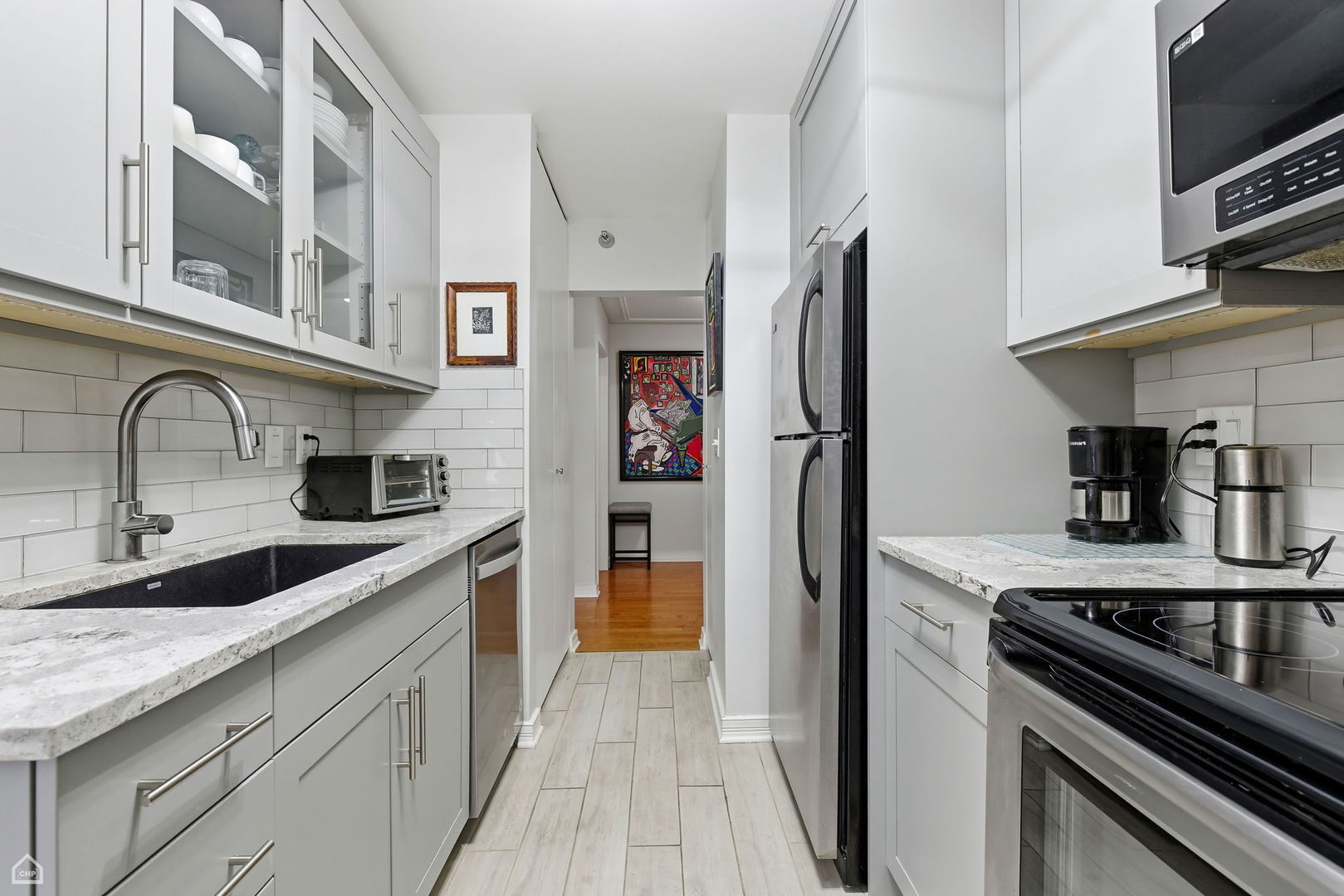 401 East Ontario Street, Unit 710 Chicago, IL 60611 - Photo 14 of 36 a kitchen with stainless steel appliances granite countertop a refrigerator and a sink