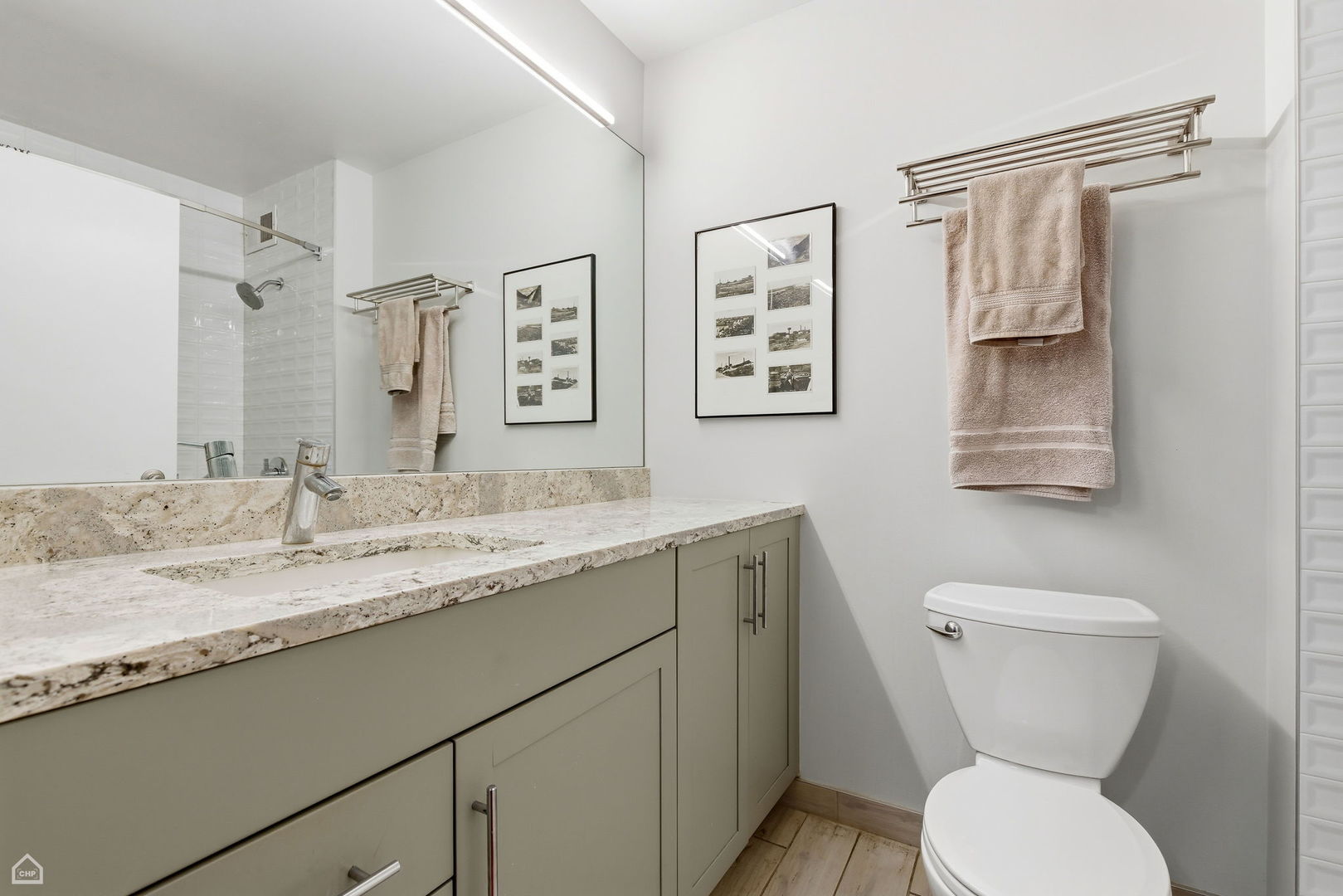 401 East Ontario Street, Unit 710 Chicago, IL 60611 - Photo 20 of 36 a bathroom with a granite countertop toilet sink and mirror