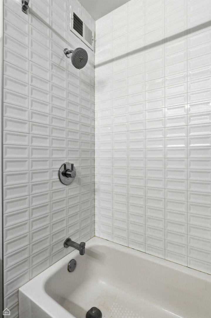 401 East Ontario Street, Unit 710 Chicago, IL 60611 - Photo 22 of 36 a bathroom with a tub and a shower