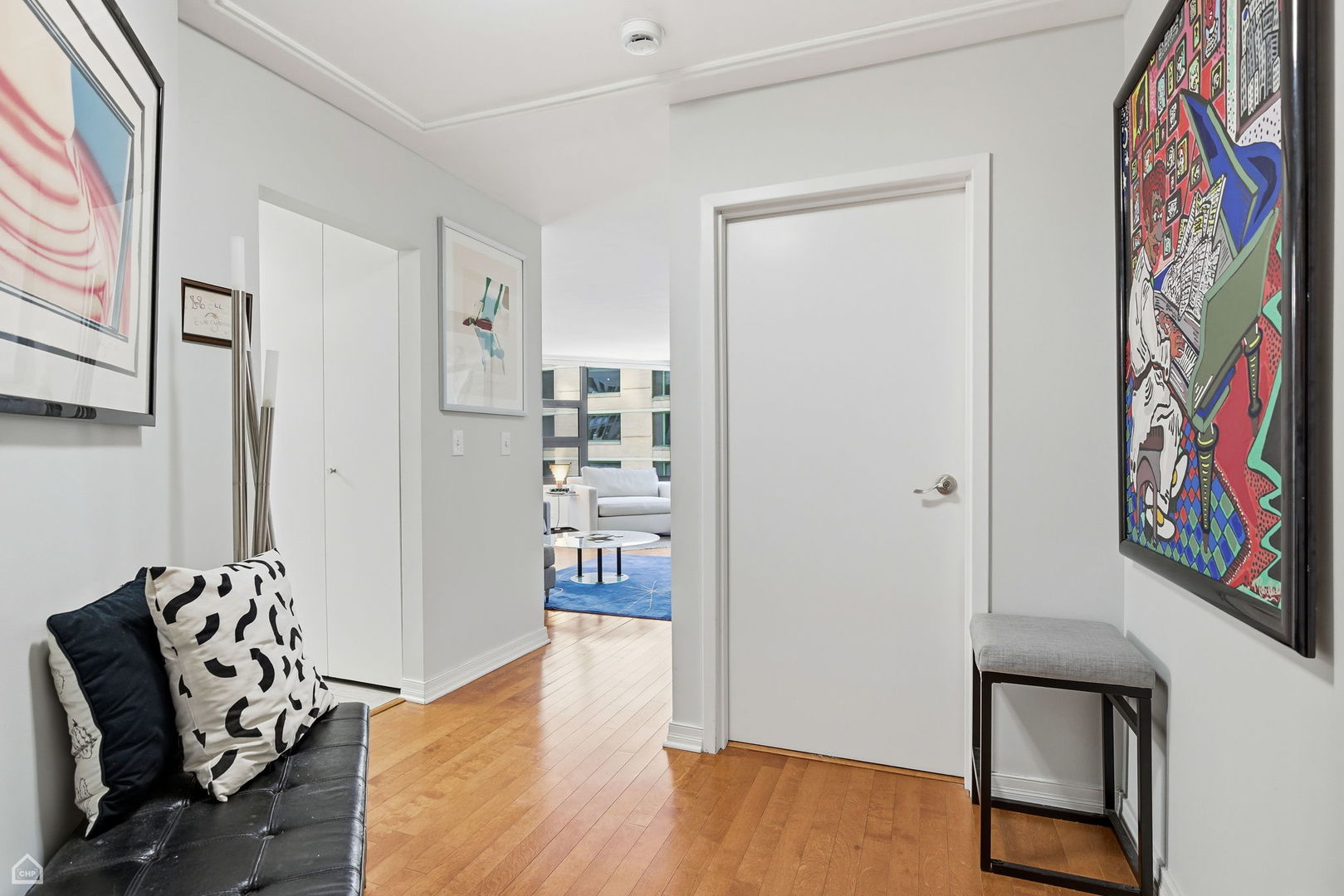401 East Ontario Street, Unit 710 Chicago, IL 60611 - Photo 23 of 36 a view of a hallway with wooden floor and furniture
