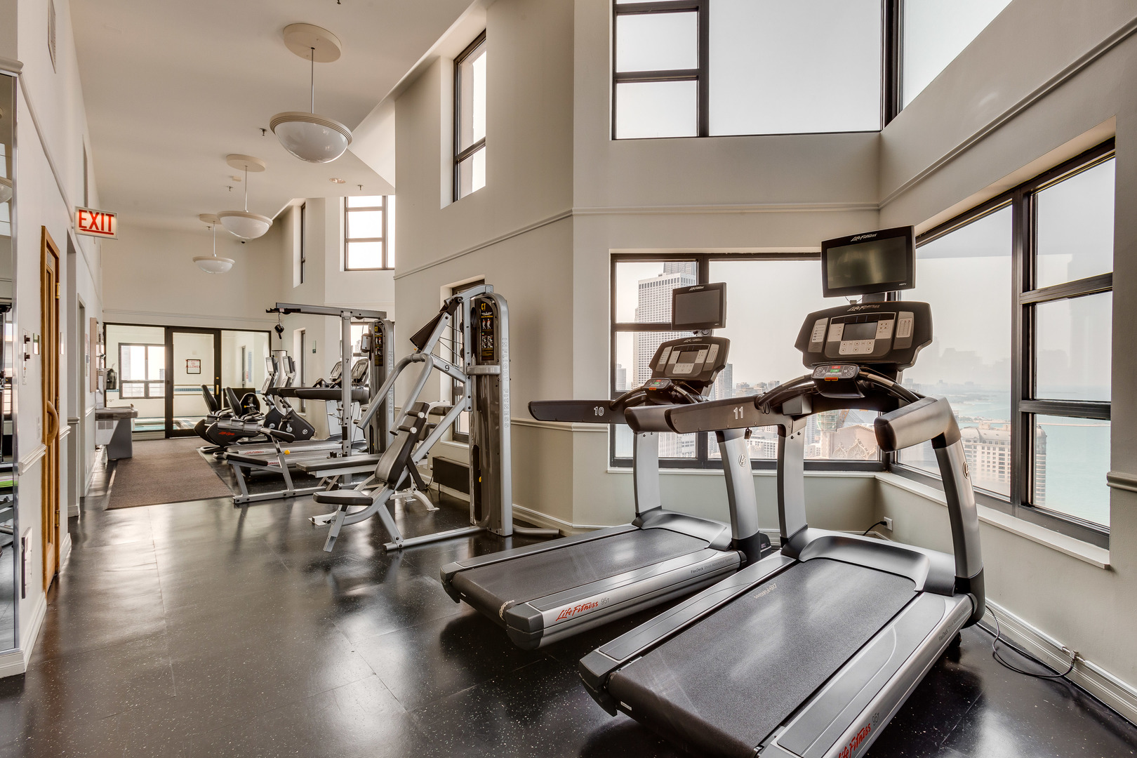 401 East Ontario Street, Unit 710 Chicago, IL 60611 - Photo 28 of 36 a room with gym equipment and wooden floor